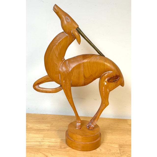 Italian Carved Limed Pine & Brass Deer Sculpture, 1970s Description An elegant Italian deer sculpture carved in limed pine...