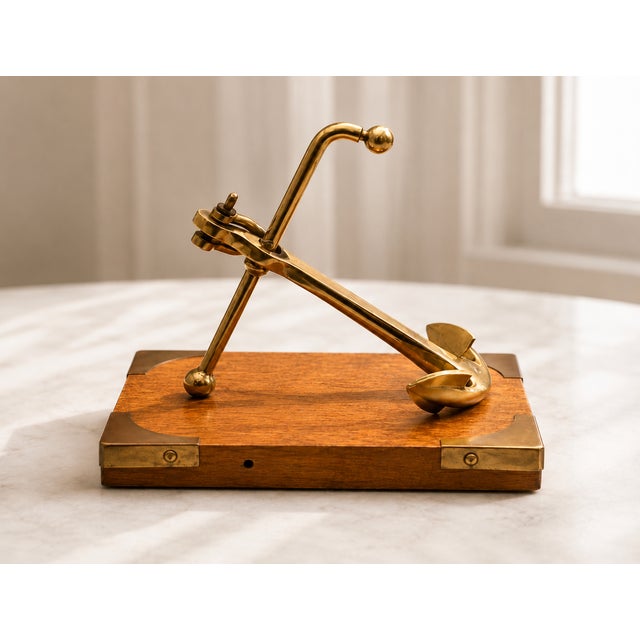 An elegant mid-century desk sculpture featuring a heavy, solid brass naval anchor masterfully mounted on a high-quality...