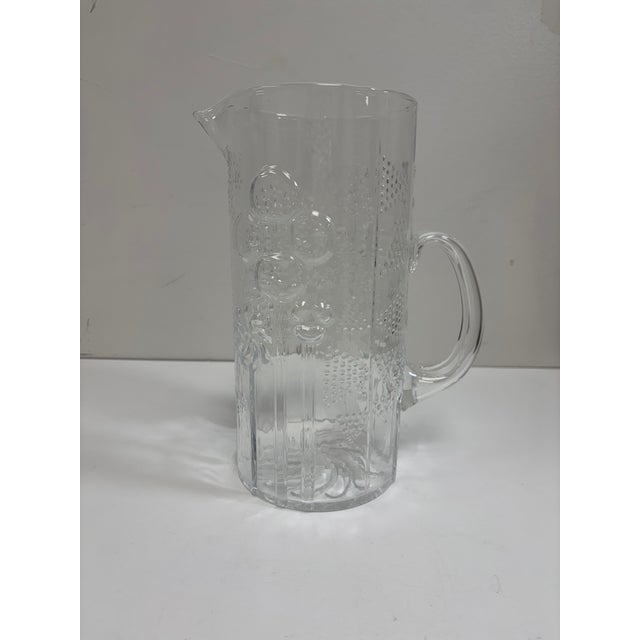 Iittala 64 oz. pitcher designed by award-winning Oiva Toikka from the Flora Line. Lovely design featuring flowers and...