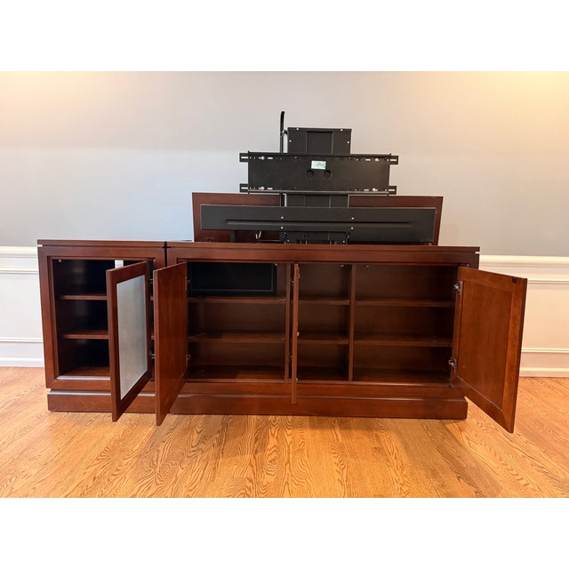 Solid cherry wood media console with motorized tv lift. Crafted by Hooker Furniture USA circa 2001. Lift will support an...