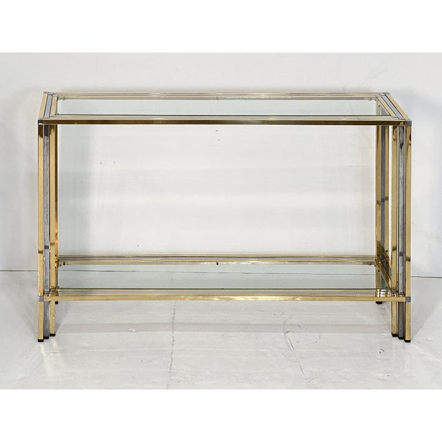 A fine Italian Modern rectangular two-tiered console table of stylish brass and chrome by the celebrated modern designer,...