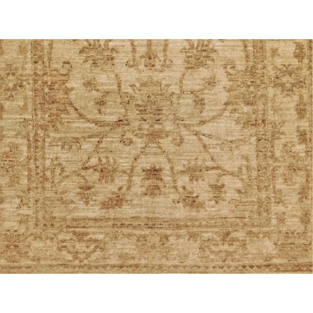 Tone on tone. natural undyed wool pile on cotton foundation. Stylized floral display. Border decorated with similar...