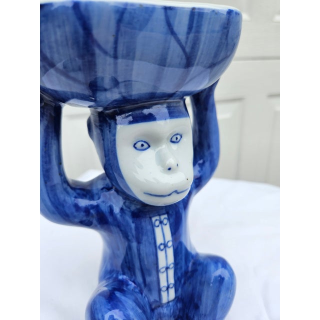 A whimsical blue and white porcelain or ceramic Chinoiserie monkey dish in the French Singerie tradition (human-like...