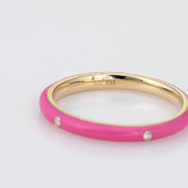Stylish candy pink enamel & diamond stacking band crafted in 14 karat yellow gold. 5 round brilliant cut diamonds total an...