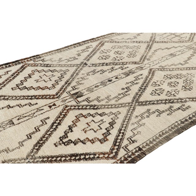 Hand-knotted in wool and originating from Morocco circa 1950-1960, this 6x11 vintage Moroccan rug is an extremely rare...