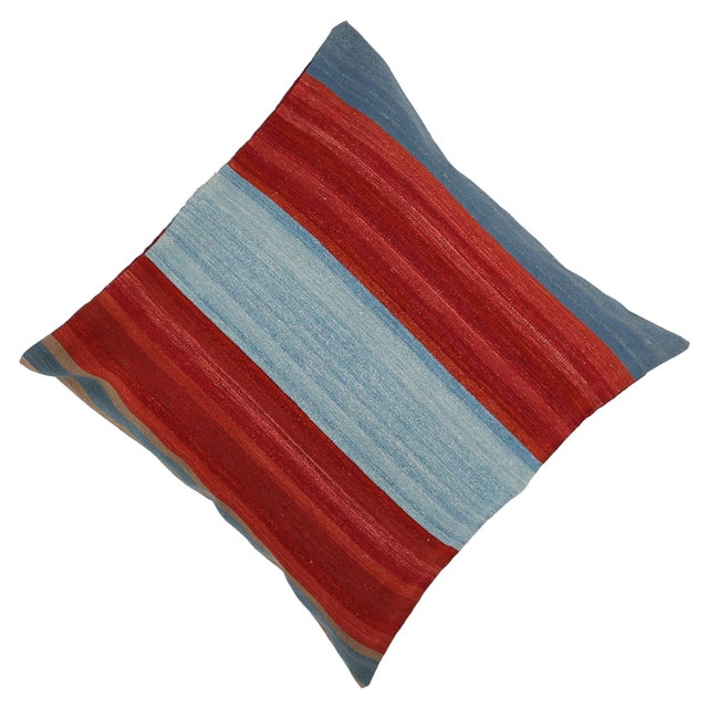 A one-of-a-kind handwoven wool kilim floor pillow featuring bold red and slate-blue horizontal color-blocks. Fully...