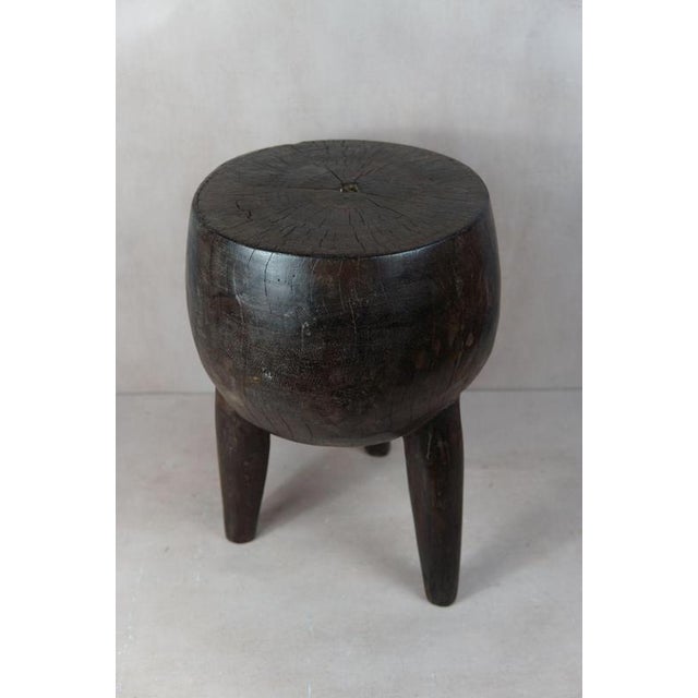Introduce a touch of African elegance into your living space with this remarkable, solid wood carved side table/stool from...