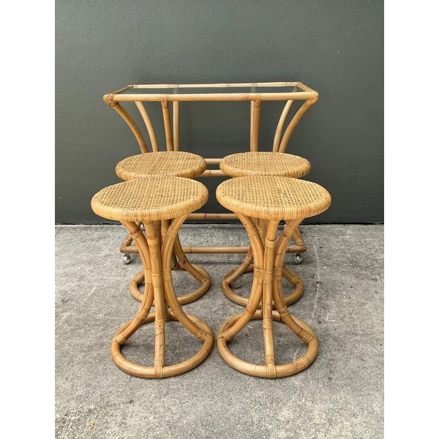 This vintage rattan high-top table set captures the relaxed sophistication of mid-century tropical design, combining...