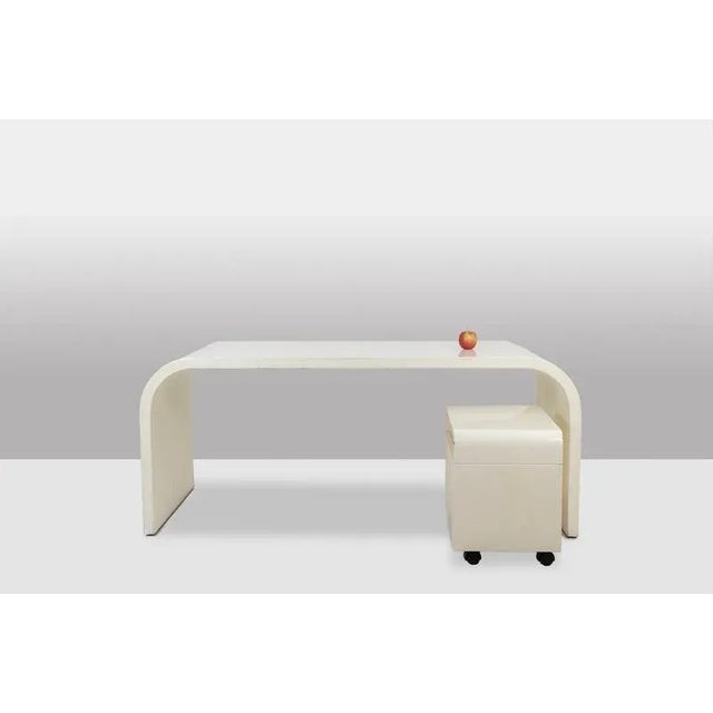 Desk and its box in white lacquered plywood, the box opening with four drawers. French work realized in the 1970s. This...