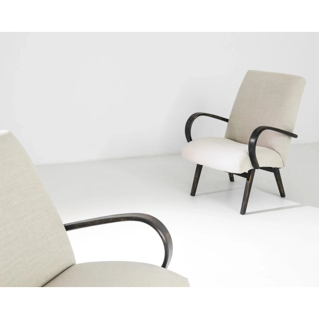 Bentwood upholstered lounge chairs by Czech furniture designer J. Halabala, circa 1930. A Mid-Century Modern silhouette is...