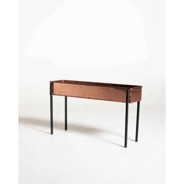 Copper sheet flower stand with a long rectangular basin and a black-painted metal frame. Scandinavian production, 1960s....