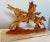 Elegant mid century lucite running horses sculpture sit on a marble base. In a warm orange to amber color. The translucent...