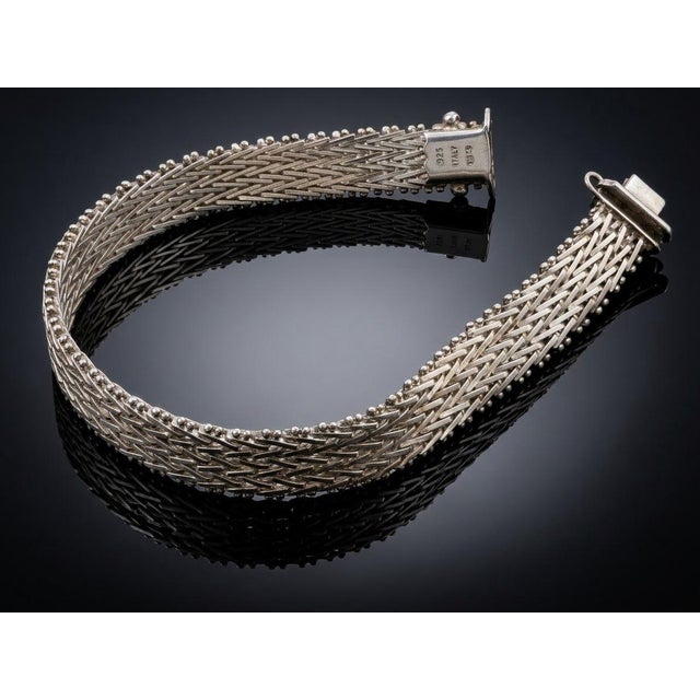 Crafted with Italian artistry, this vintage Milor sterling silver bracelet features a woven mesh design framed by beaded...