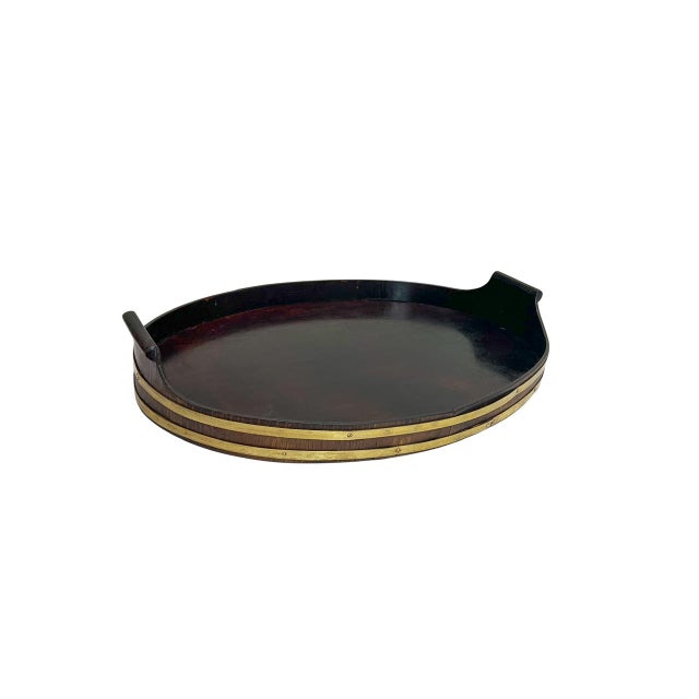 An antique tray dating from around 1880, handcrafted from dark walnut with brass strips. Featuring round, hand-carved...