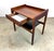 A walnut Jens Risom nightstand with floating drawer and black leatherette covered lower shelf, circa 1960’s. Unsigned. Top...