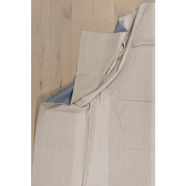 Room size Turkish Kilim in ivory and brown made from recycled cotton and goat hair material giving it an old world,...