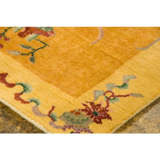 Hand-knotted in wool, this 3x6 contemporary Chinese Deco runner presents a golden-yellow field framed by a delicate...