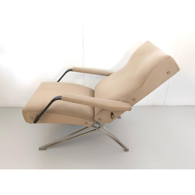 Made in Italy, 1960s. This chair features a metal frame and it's upholstered in beige fabric. It may show slight traces of...