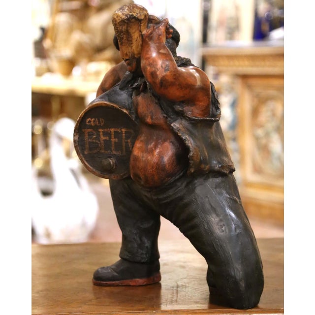 Full of humor and old-world pub character, this unusual antique figure depicts a jovial beer drinker raising a frothy mug...