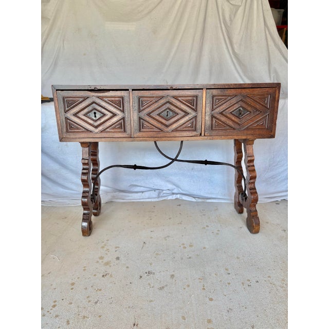 This 19th Century Spanish Walnut and Iron Three Drawer Console Table dates back to the 1700's. The piece features a hand-...
