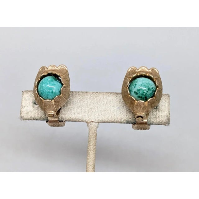1950s goldtone ridged texture spherical faux-speckled green jade clip earrings. Marked "NAPIER PAT. PEND." on both the...