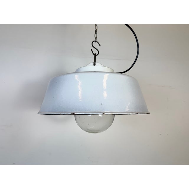 Industrial light grey enamel factory pendant light made in former Czechoslovakia during the 1960s. White enamel inside the...