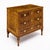 An elegant three-drawer commode showcasing beautifully figured walnut veneers arranged in a sophisticated symmetrical...