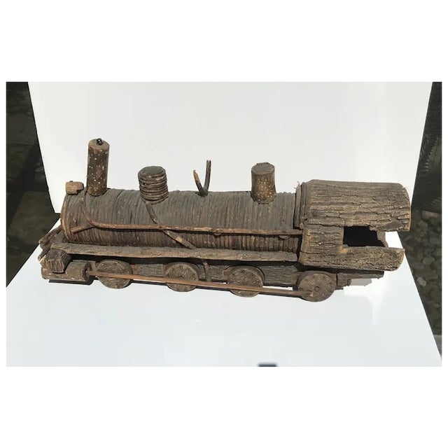C.1920 Folkart wooden train in the form of an 20th C. Steam locomotive. Made of twigs, bark and pine. Wheels actually...