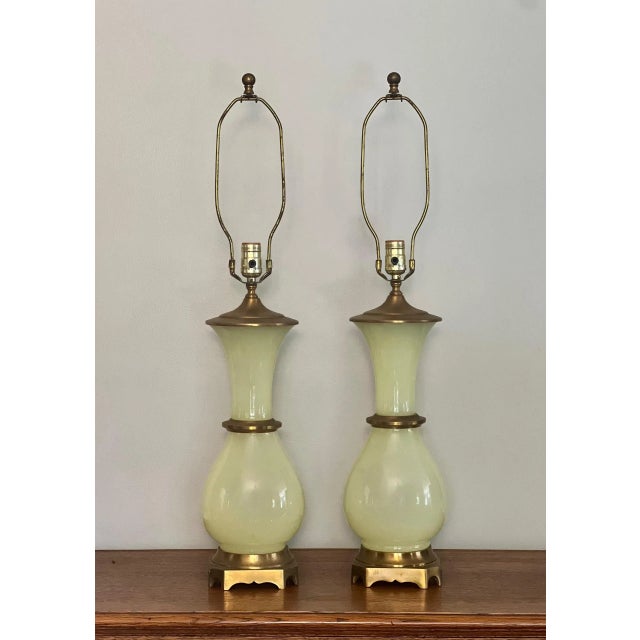 Rare and elegant pair of mid century Hollywood Regency bronze-mounted uranium glass lamps by Paul Hansen. Gorgeous lamps...