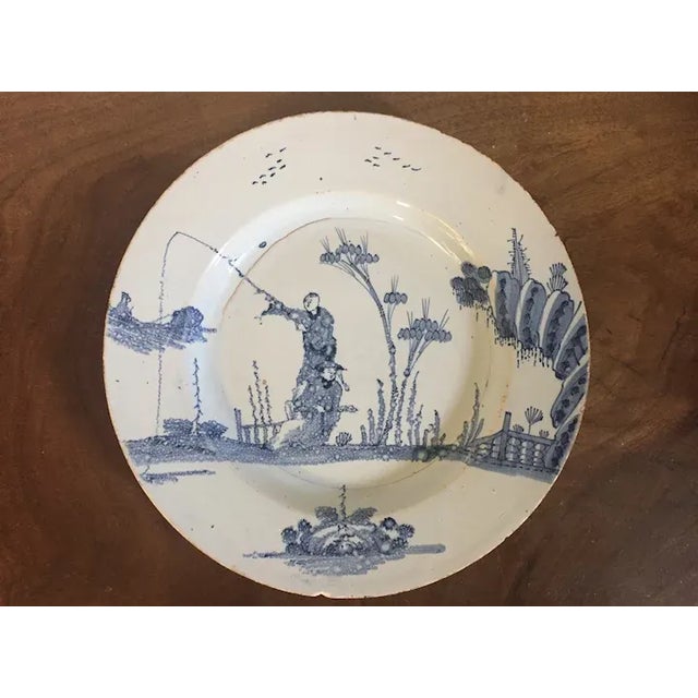 Antique 18th c. English Delft charger or round platter with Chinoiserie decoration showing figures in a landscape. A...