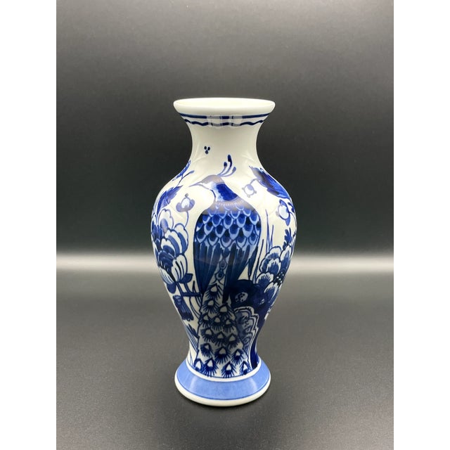 Showcasing the artistry of Dutch ceramics, this Royal Delft blue hand-painted vase features the iconic peacock design, a...