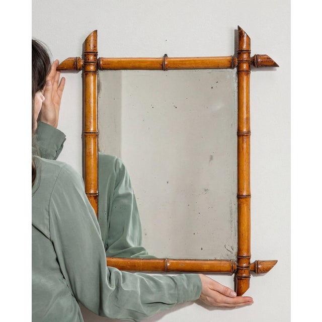 Here is a mirror, its faux bamboo, honey/amber wood the first thing to catch the eye. The piece dates to 1900s, sourced...