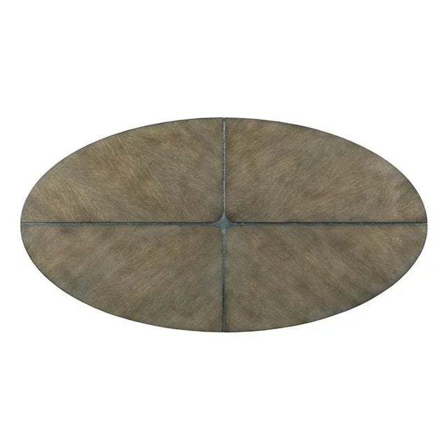 The metal legs of this cocktail table flow through the top forming 4 quadrants of radiating flake oak.