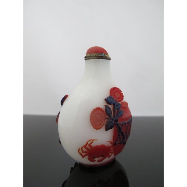 Chinese multicolor overlay peking glass snuff bottle most likely from the Qing dynasty era. Traditional Chinese carvings...