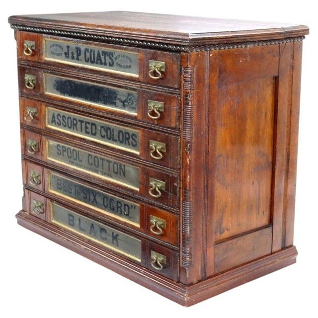 Antique J. & P. Coats six-drawer spool cabinet, circa 1890, made of walnut with brass drawer pulls and applied advertising...