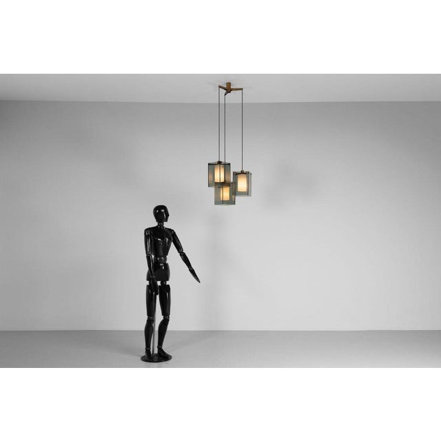 This exquisite triple pendant lamp, model 2210, was designed by Max Ingrand and manufactured by Fontana Arte in Italy,...