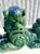 A stunning pair of glazed ceramic Foo Dogs, beautifully rendered in a rich emerald green glaze with striking flashes of...