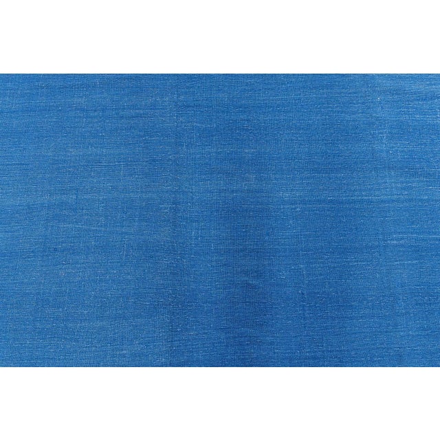 This striking circa 1955 Indian Dhurrie rug exemplifies the refined simplicity and craftsmanship characteristic of mid-...