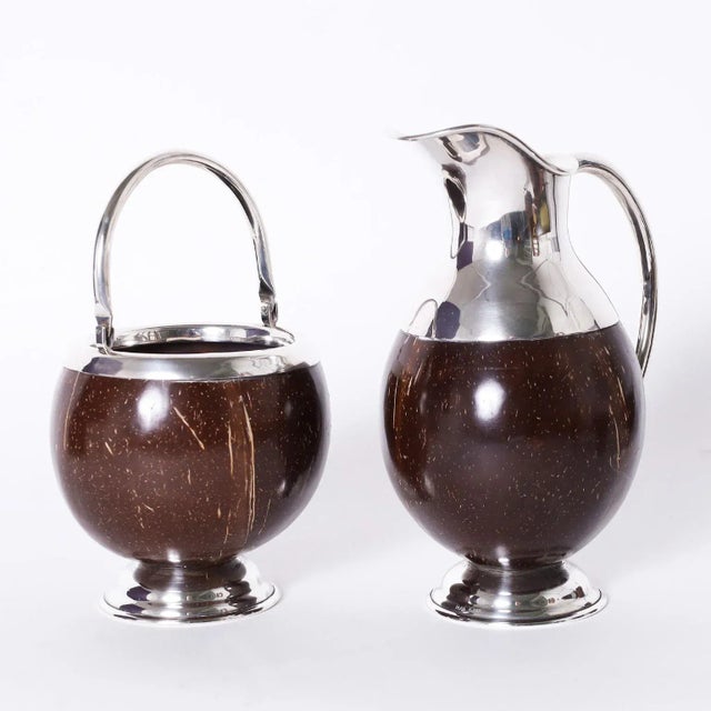 Dapper set of eight mid-century serving pieces with an elegant modern form crafted in polished coconut and hand made...