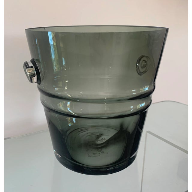 An ice bucket or wine cooler in a gorgeous, heavy, smokey grey glass. Two holding points on the sides allow for a solid...