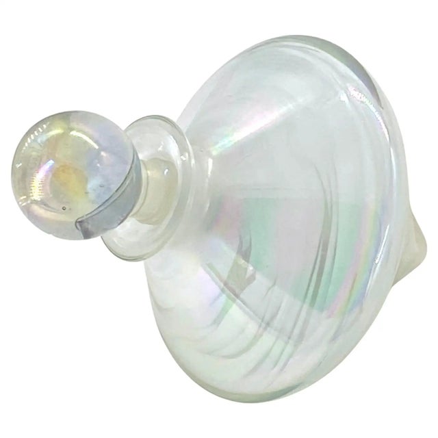 This is a aurora borealis coated art glass spinning top shaped perfume bottle with a ball shaped stopper. It would be a...