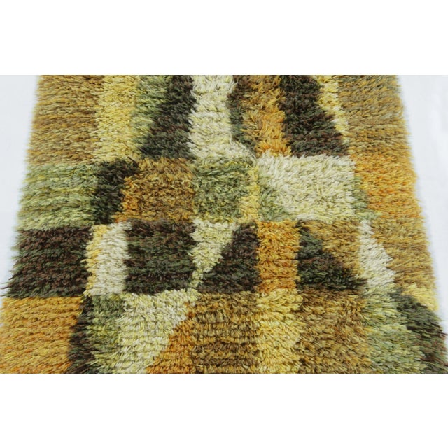 Hand-knotted in lush, high-pile wool in Sweden circa 1960-1970, this 2x4 vintage Swedish Rya runner rug is a bold new...