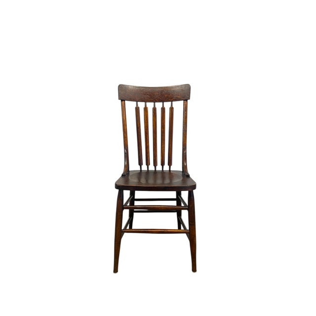 This antique Windsor side chair embodies the Arts and Crafts movement's emphasis on simplicity, craftsmanship, and the...