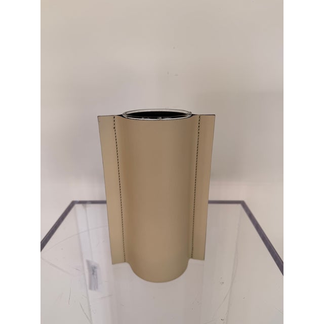 Contemporary leather vase featuring a sleek glass cylindrical vase wrapped in removable smooth leather sleeve with refined...