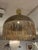 Design Plus Gallery presents the Verge Pendant from Shine by S.H.O. A hammered brass dome catches the eye with a luminous...
