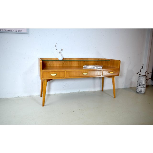 This is a classic mid-century console table with clean, elegant lines. The cabinet was manufactured in the 1950s by the...