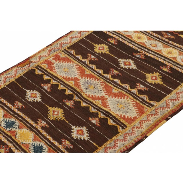 Handwoven in wool circa 1950-1960, this 4x8 vintage Moroccan Kilim and Berber rug is an exciting new unveiling from the...