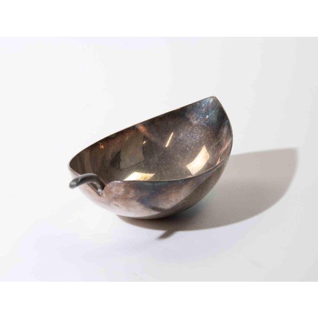 Elegant modernist silver-plated serving dish in an organic leaf-inspired form, featuring an elongated asymmetrical bowl...