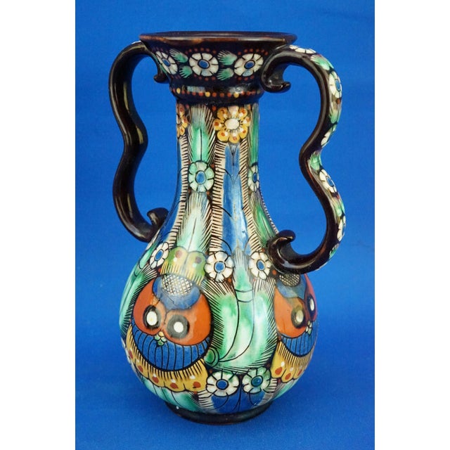 A beautiful two-handled vase in glazed and vitrified majolica ceramic, entirely hand-modeled on a lathe and decorated by...