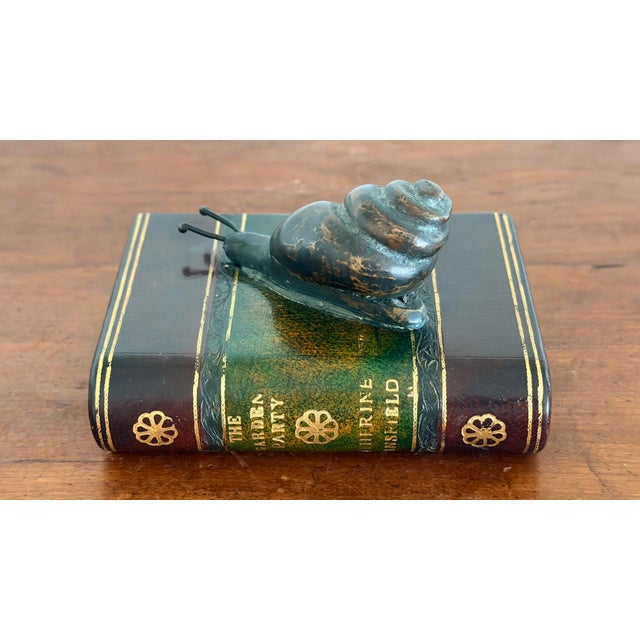 Charming Maitland Smith Bronze Snail On Book Paperweight. Paperweight is with a bronze snail on a faux leather bound copy...